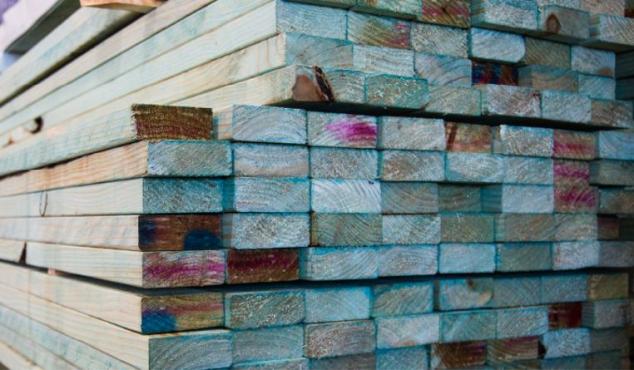 Image from first screen of webinar- a stack of timber in timber yard