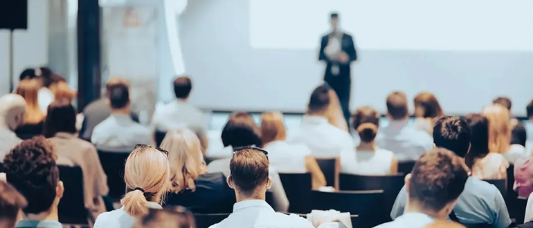 presenter with conference audience in large room