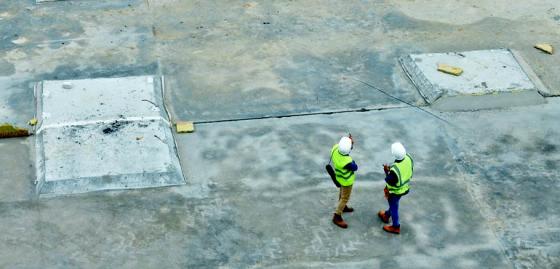 Workers inspecting on concrete expanse